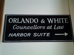Orlando & White's sign in the Blackburn building. It now hangs in the hallway outside of Attorney Orlando's office. 