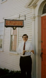 Attorney White, holding the first dollar made at the Orlando & White office in New Bedford, 1984. 